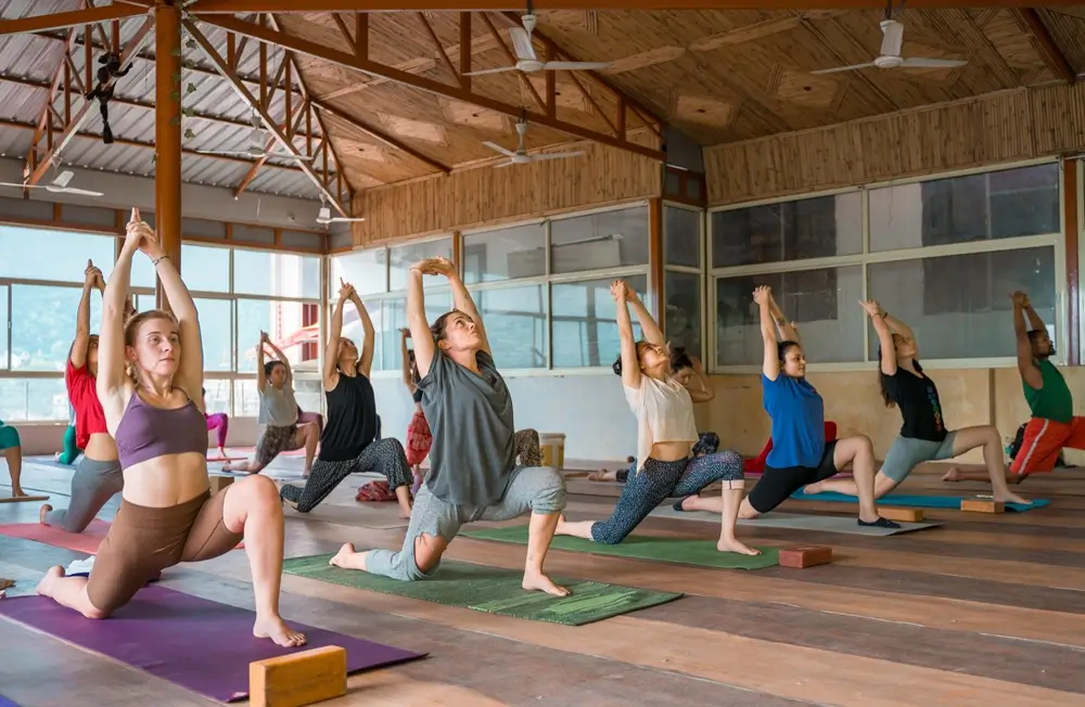 Students practicing yoga in a group class at a yoga studio