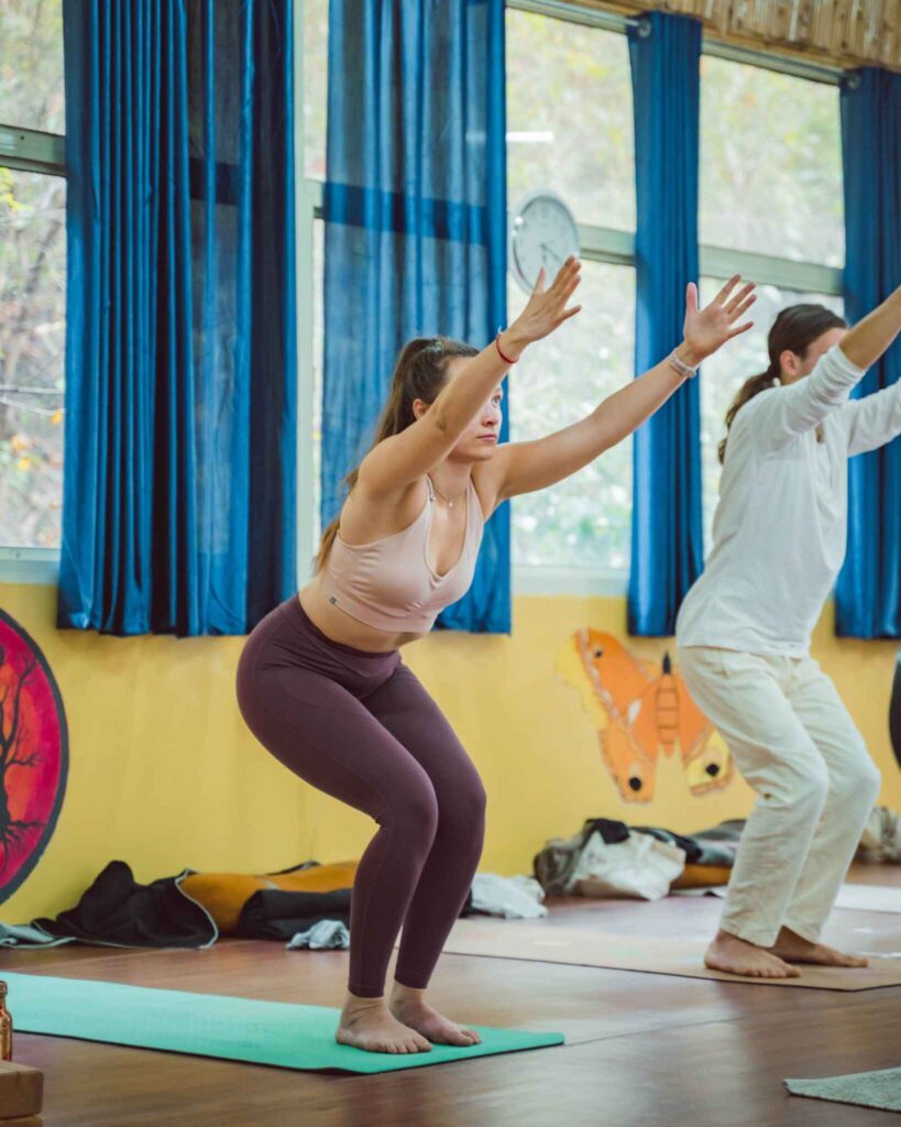 Utkatasana Chair Pose practiced by yoga students in a class