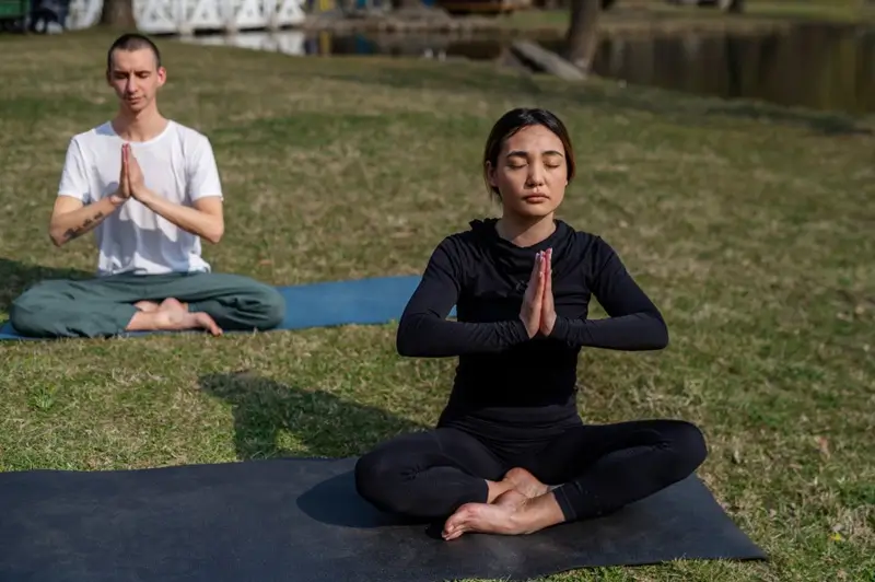 People practicing Kundalini yoga meditation outdoors