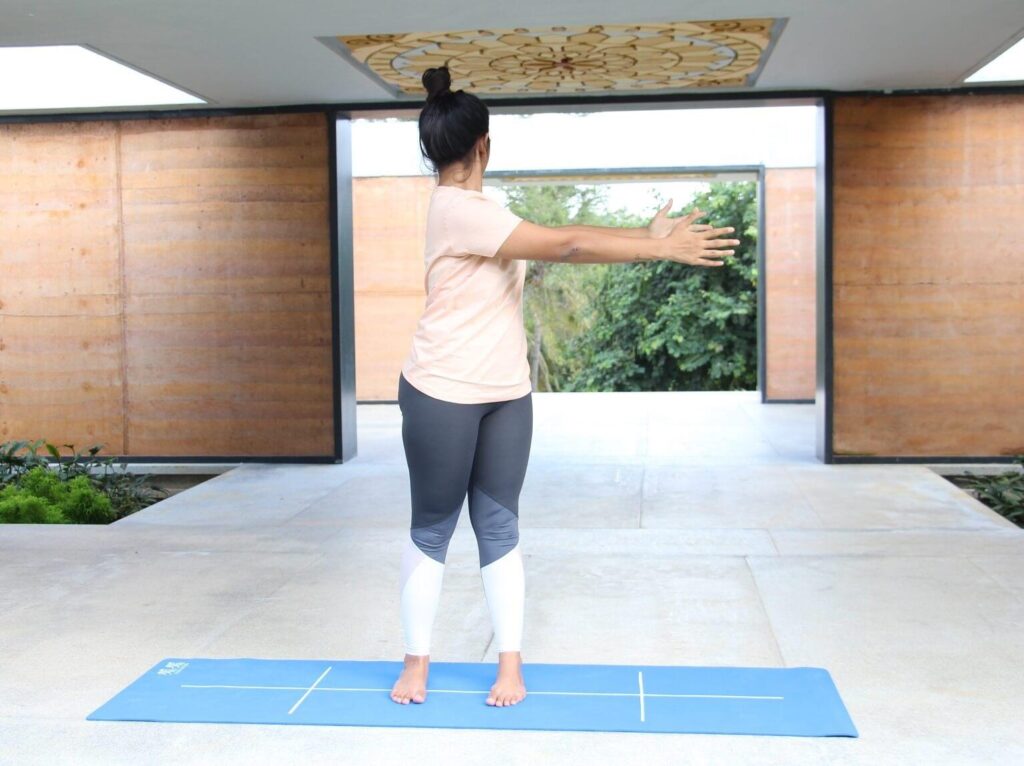 Woman practicing standing spinal twist