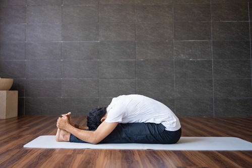 A Man Practising Paschimottanasana A Man Practising Paschimottanasana