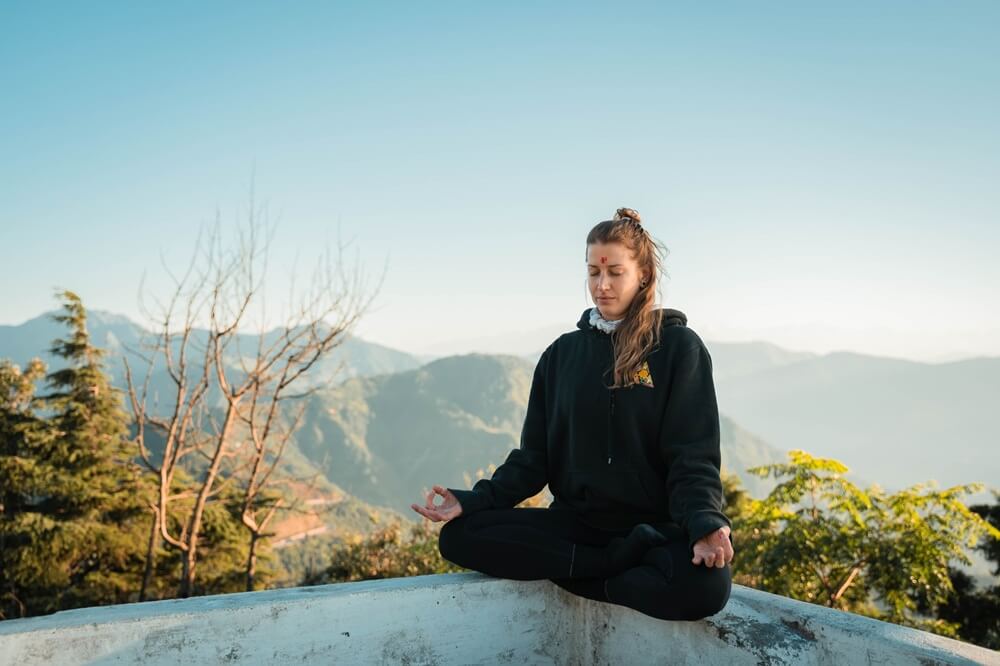 Woman Practicing Meditation Yoga With Mountain View